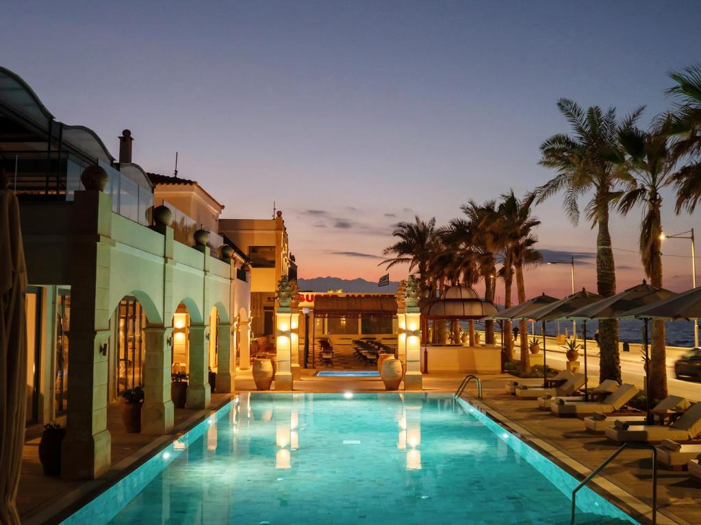 Grecotel Plaza Beach House pool lit up at dusk