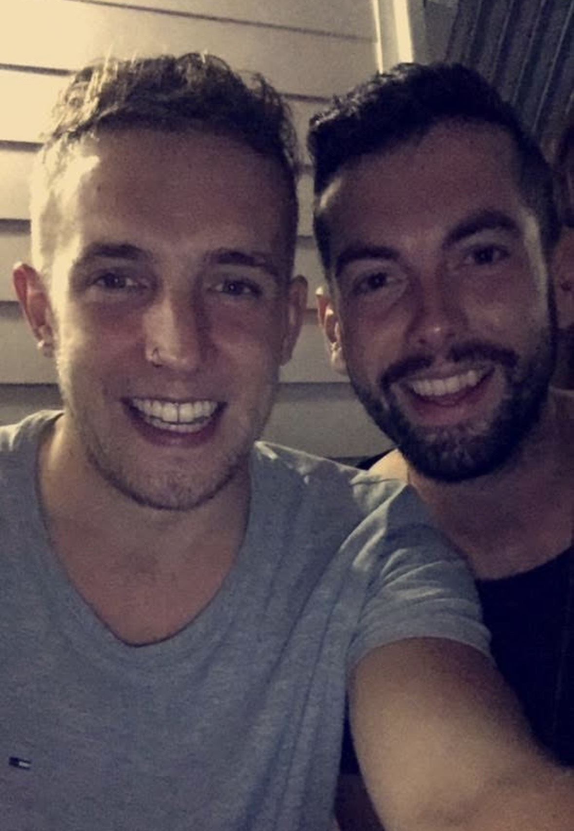 Mark and Mikey grinning together in a cosy selfie