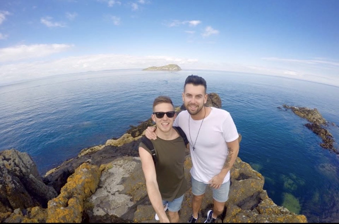 Mark and Mikey on rocky cliffs above a deep blue sea